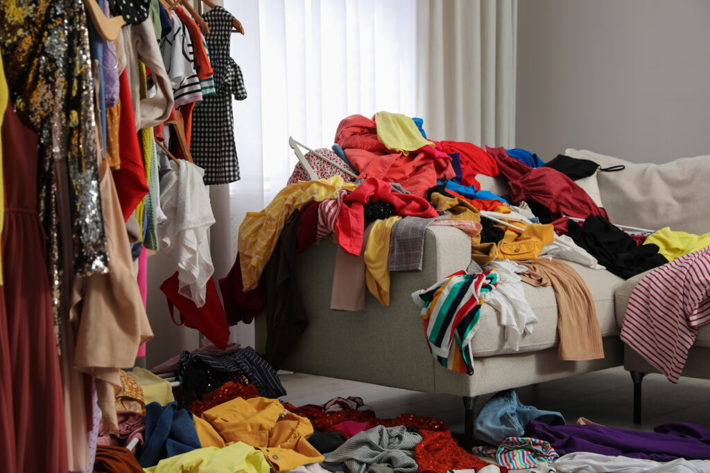 Des vêtements de fast fashion éparpillés partout dans la pièce.